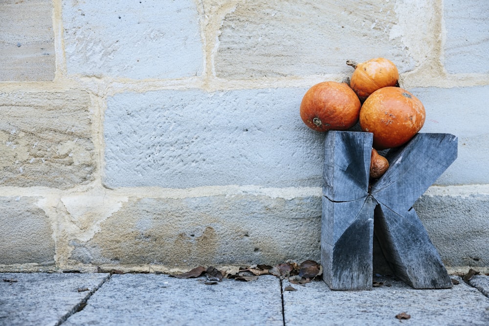 a pile of pumpkins sitting on top of a wooden block