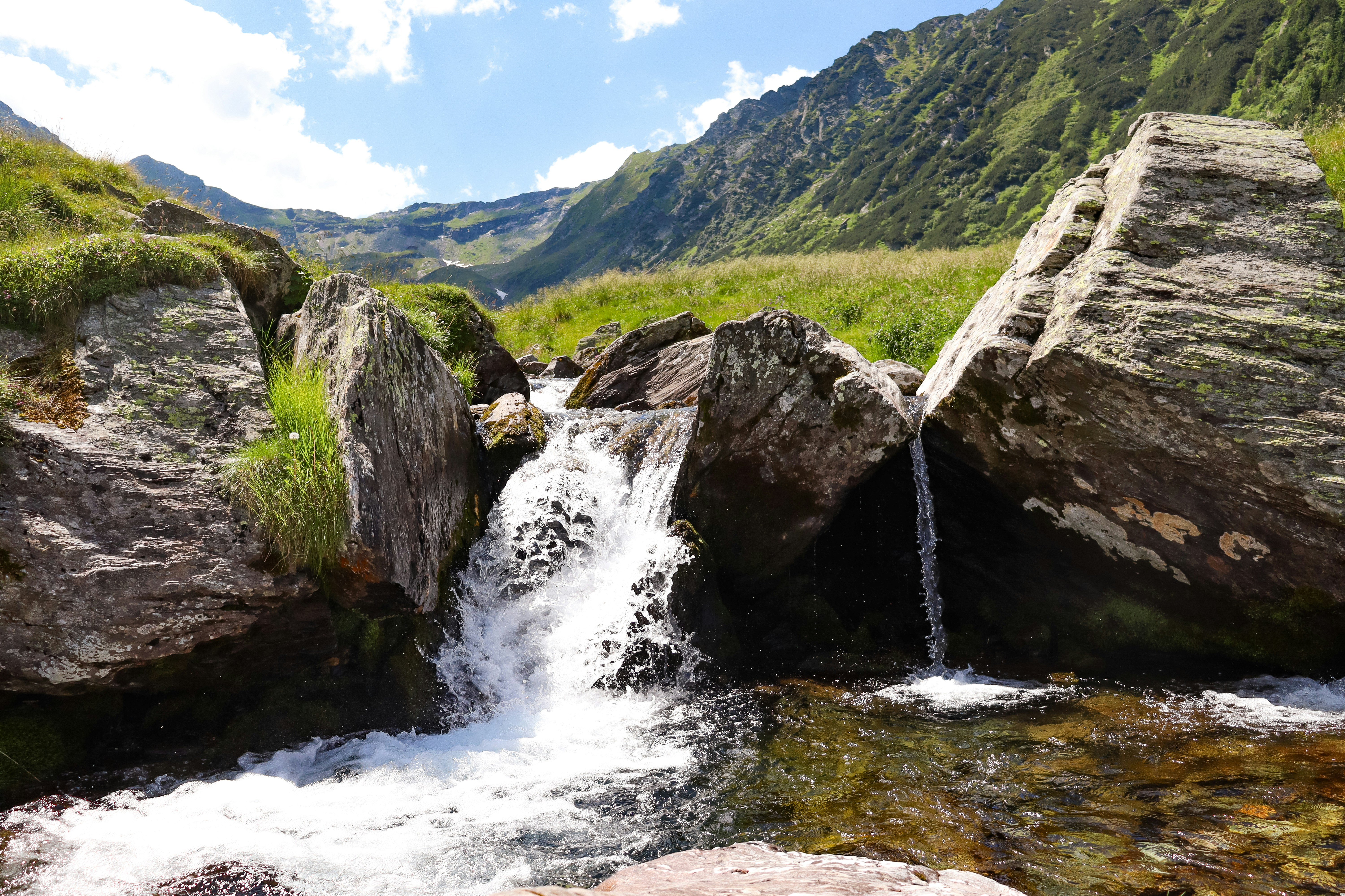 a stream of water running between two large rocks
