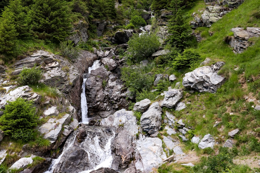 a small waterfall running down the side of a mountain