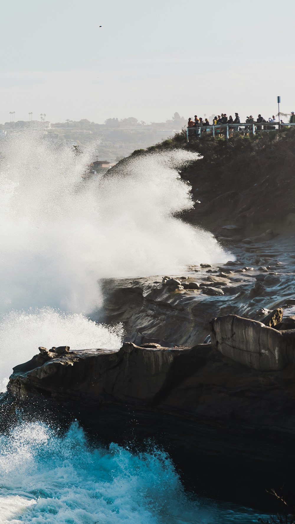 a group of people standing on top of a cliff