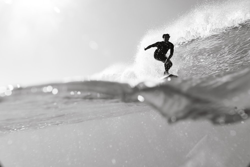 a man riding a wave on top of a surfboard