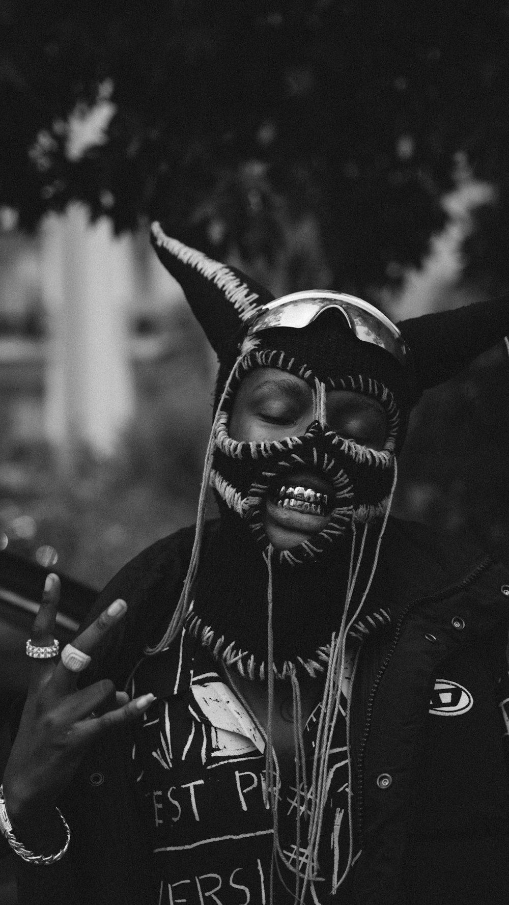 a person wearing a horned mask and smoking a cigarette