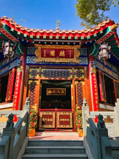 a building with a red and blue roof and stairs