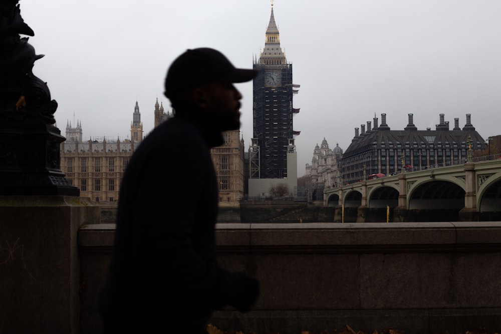 a man in a hat is looking at the skyline