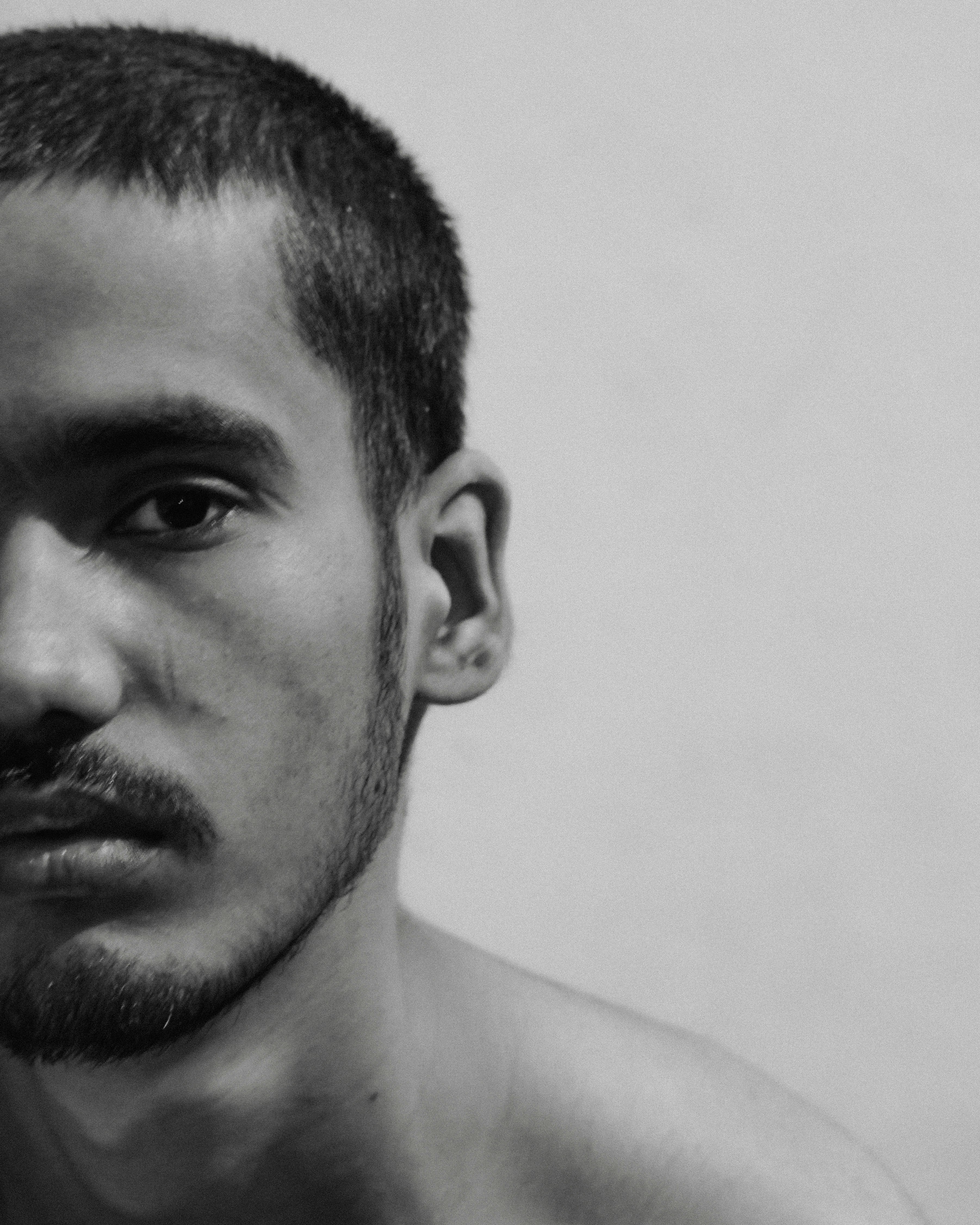 a black and white photo of a shirtless man
