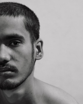 a black and white photo of a shirtless man