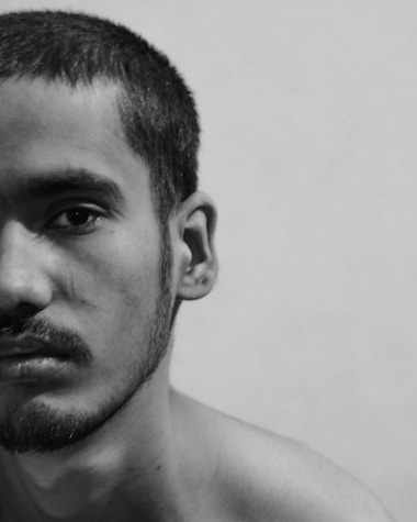 a black and white photo of a shirtless man