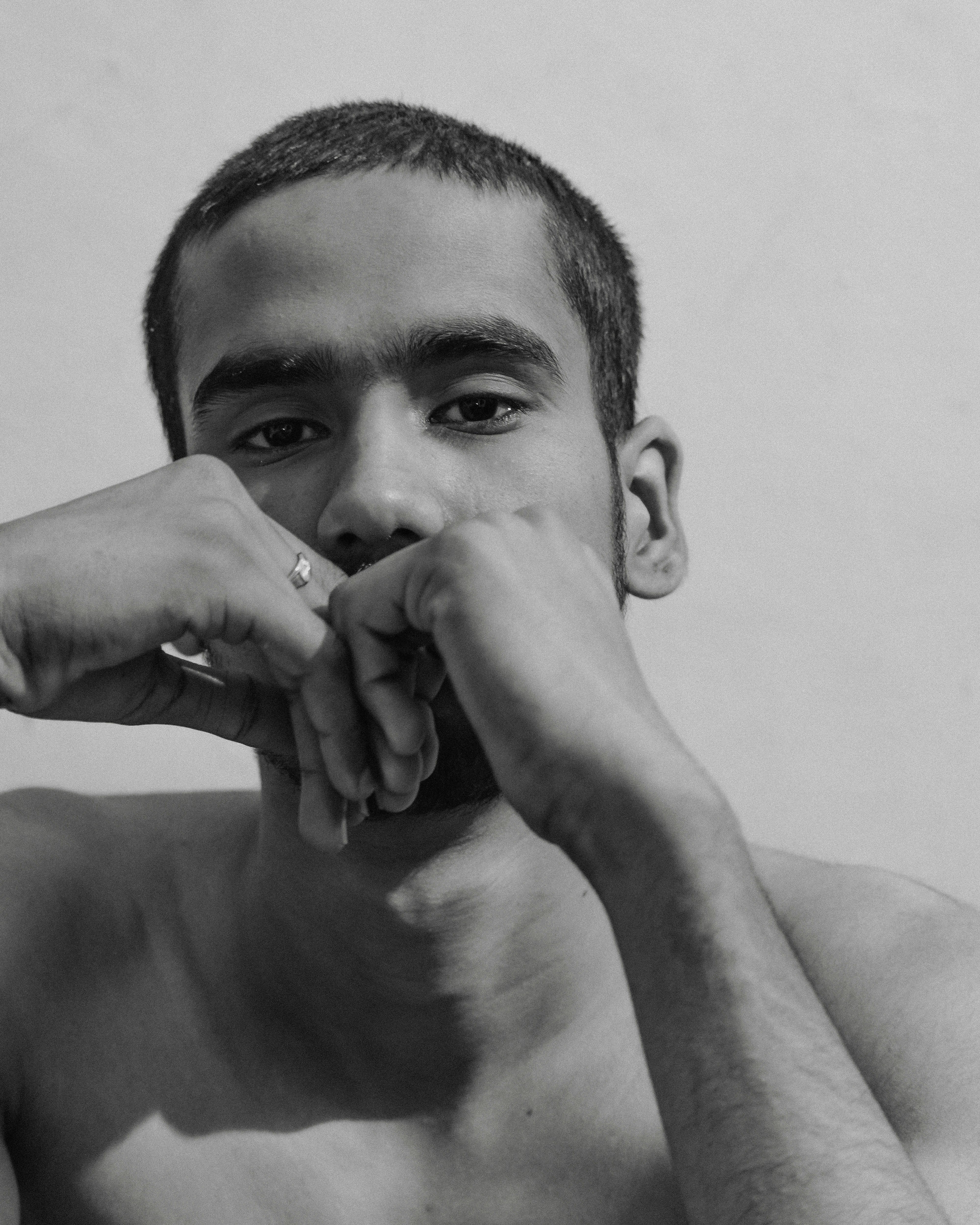 a black and white photo of a shirtless man