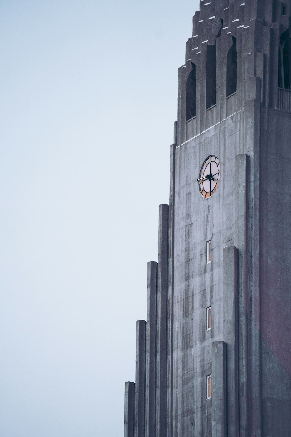a tall building with a clock on the side of it