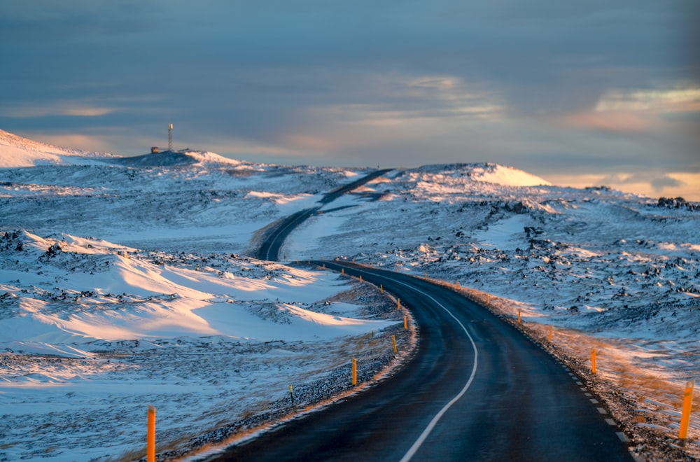 a road in the middle of a snowy landscape