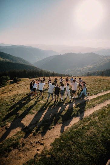 A warm group photo of Hilltop Church members gathered outdoors on a sunny day, smiling and embracing.