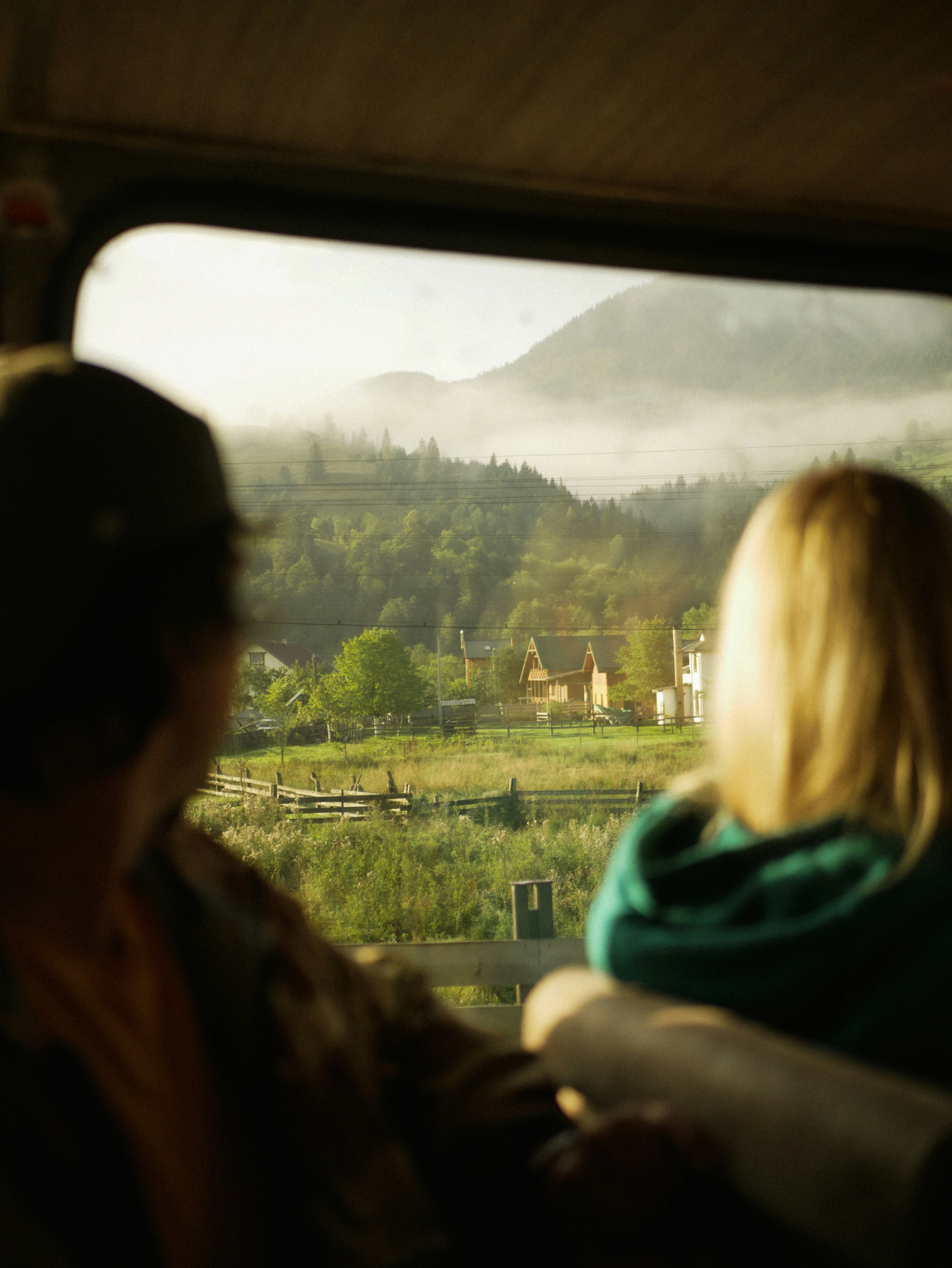 8 Scenic Train Rides That Are Cheaper (and Better) Than Flying – a man and a woman looking out a train window