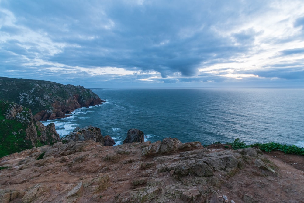 a view of the ocean from the top of a hill