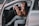A happy customer enjoying a car ride with music playing.