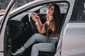 A happy customer driving away in their new car.