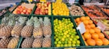 Fresh fruits and vegetables neatly arranged in a market setting.