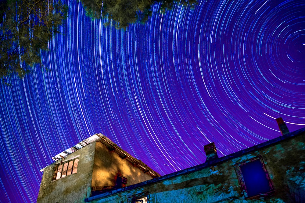 a house with a star trail in the sky