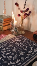 a table topped with books and a vase filled with flowers