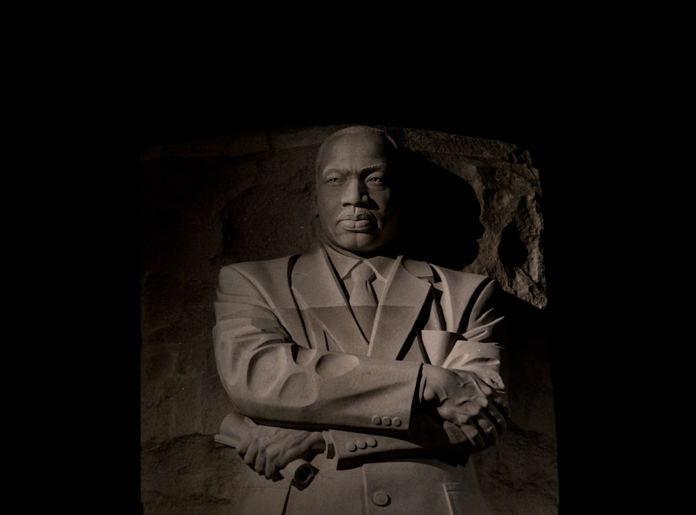 a black and white photo of a man in a suit