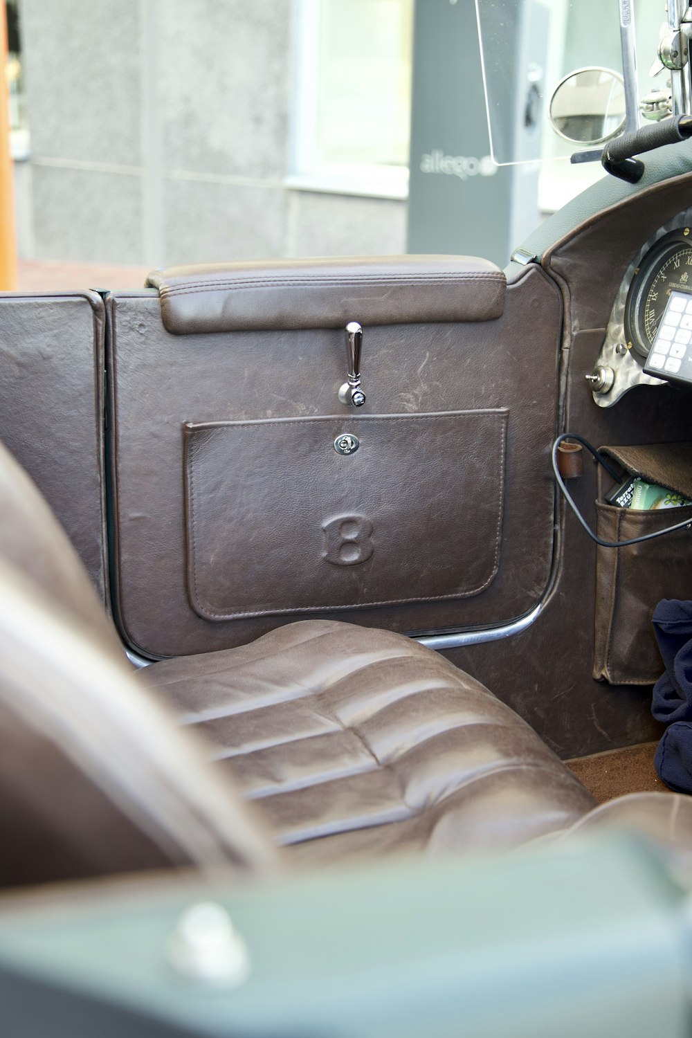 the interior of a car with a brown leather seat