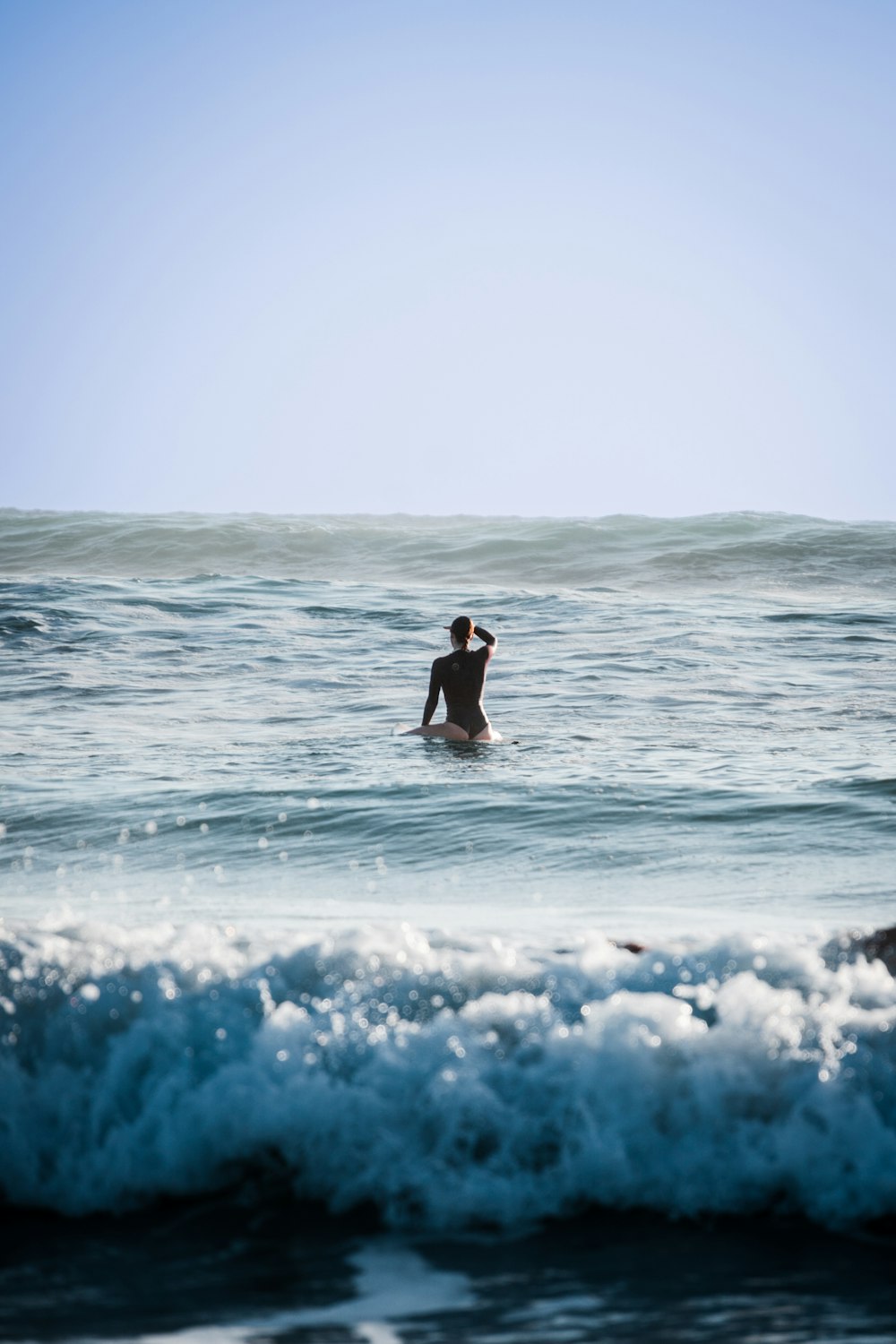 a man riding a wave on top of a surfboard