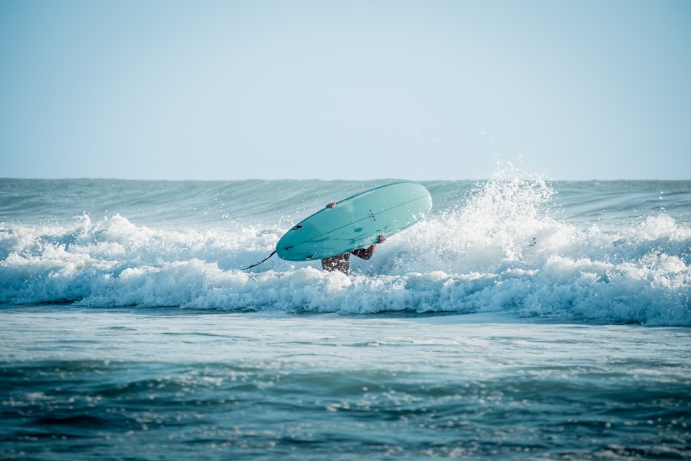 a person jumping in the air with a surfboard