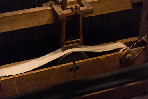 A vibrant crankie scroll unfurling against a rustic wooden backdrop, capturing the charm of folk storytelling.