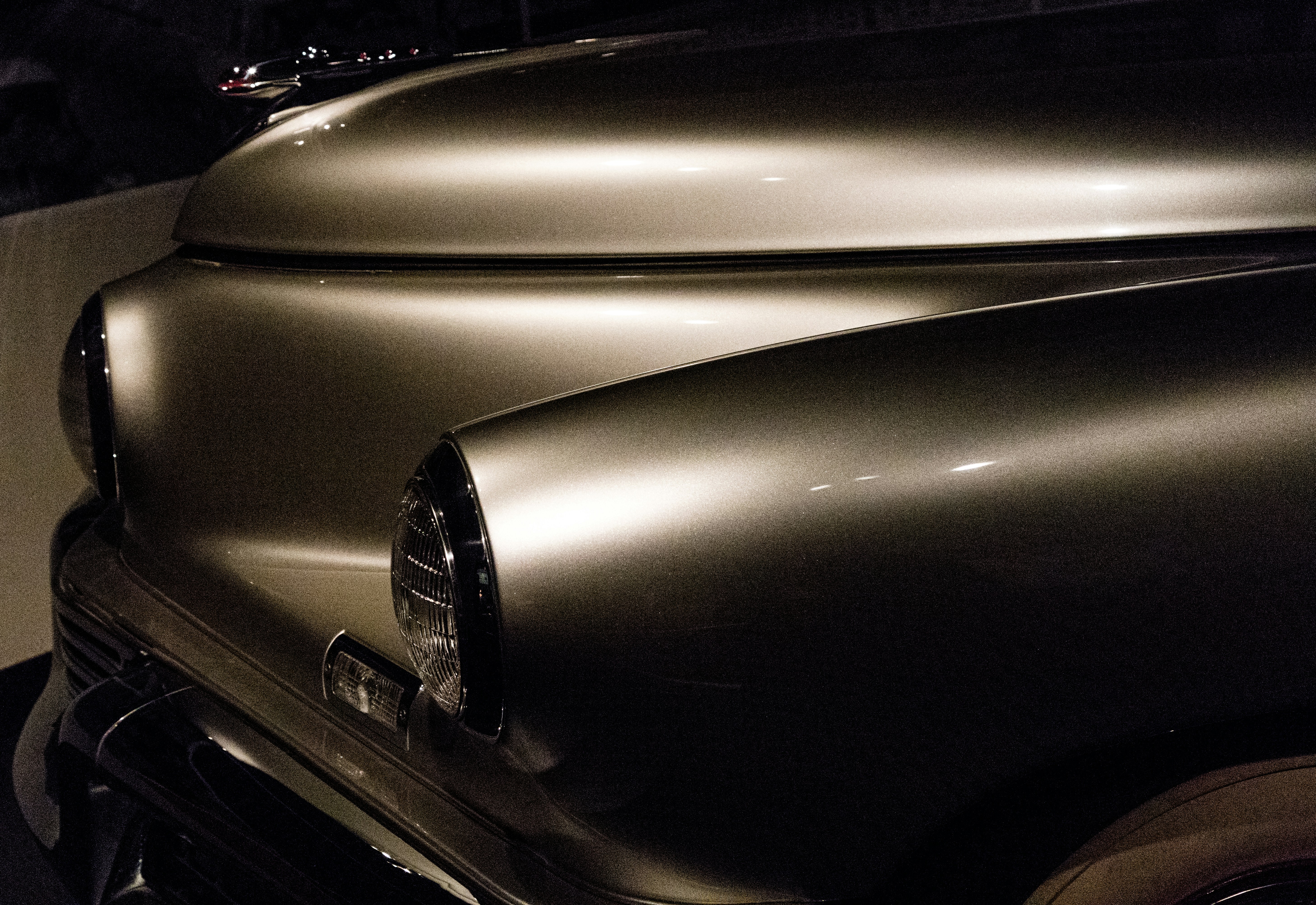 A classic car mid-painting process showing smooth, even coats of paint.