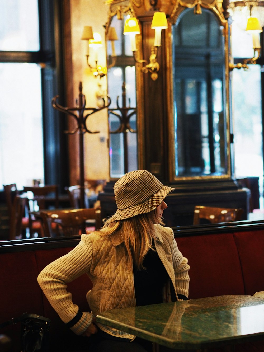 a woman sitting at a table in a restaurant