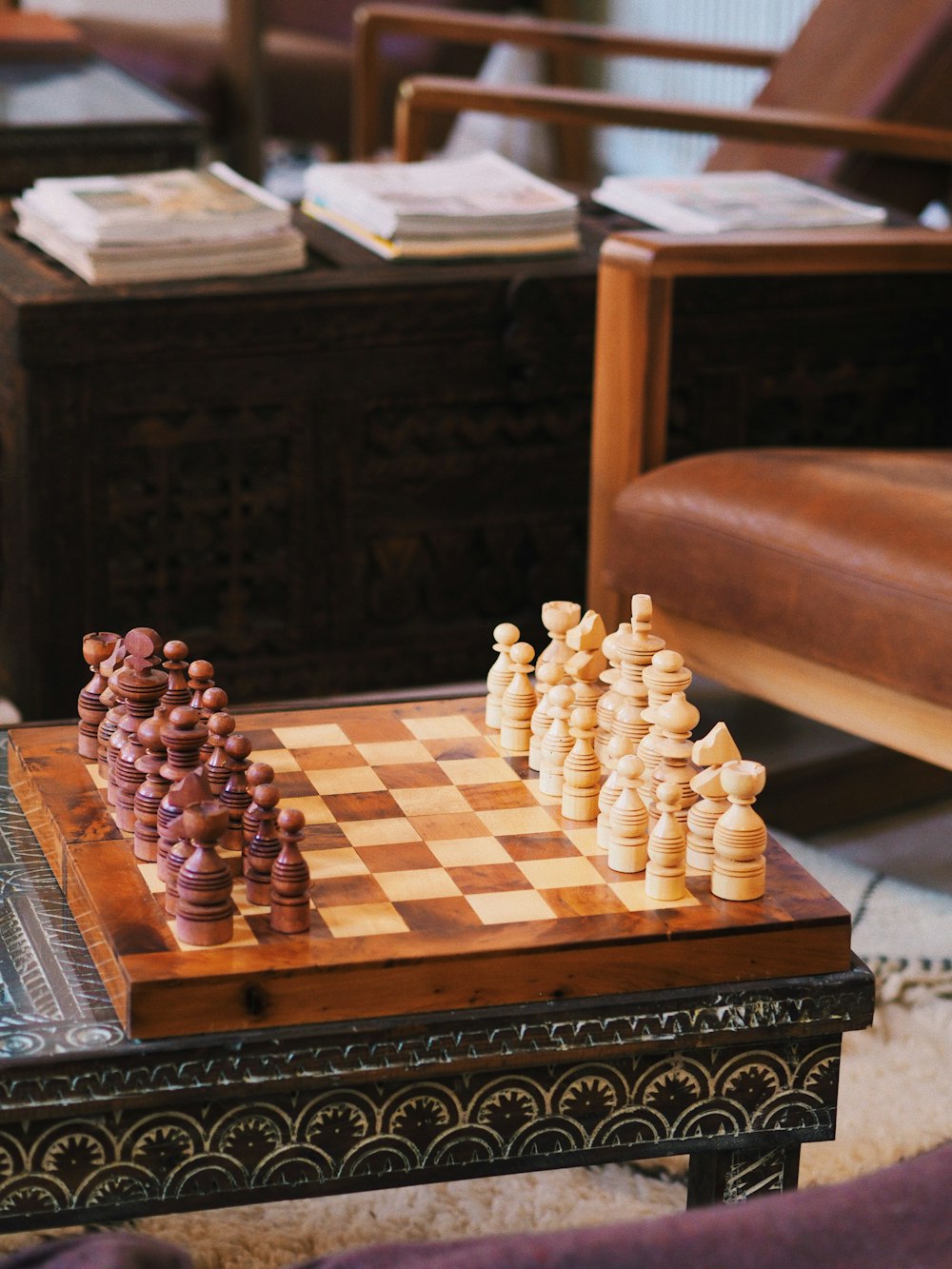 a chess board and pieces on a coffee table