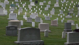 a cemetery with many headstones in the grass