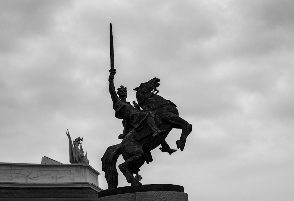 a statue of a man on a horse holding a sword