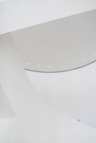 An international project stand with bold graphics and clean white surfaces under soft lighting.