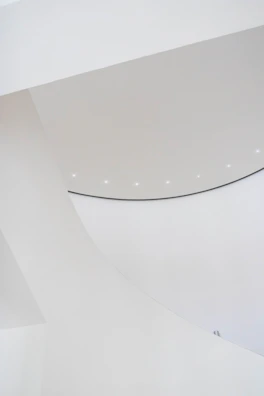 Bright, airy stand design with clean white surfaces and subtle gray tones.