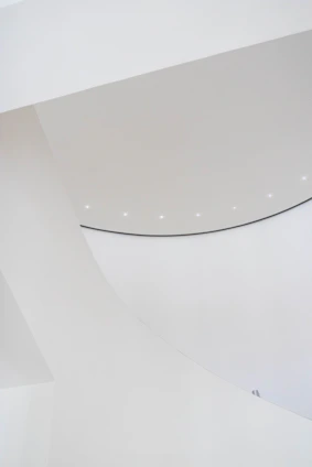 Minimalist architectural model displayed on a clean white surface with soft natural lighting.