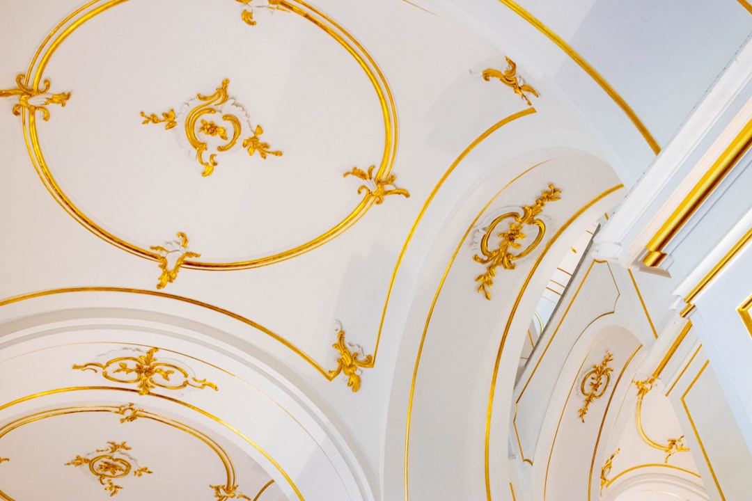 the ceiling of a church with gold decorations,