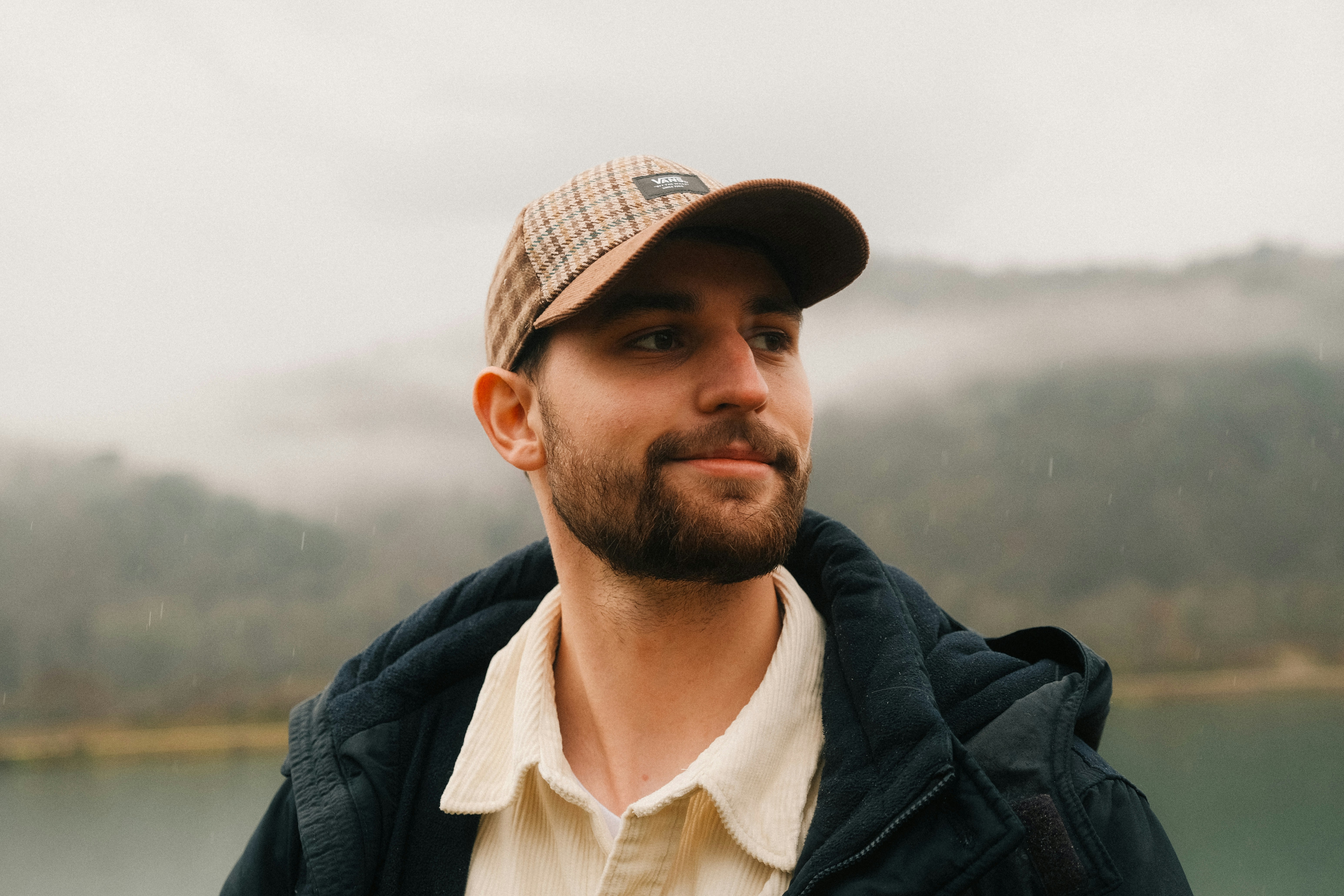 a man with a beard wearing a hat