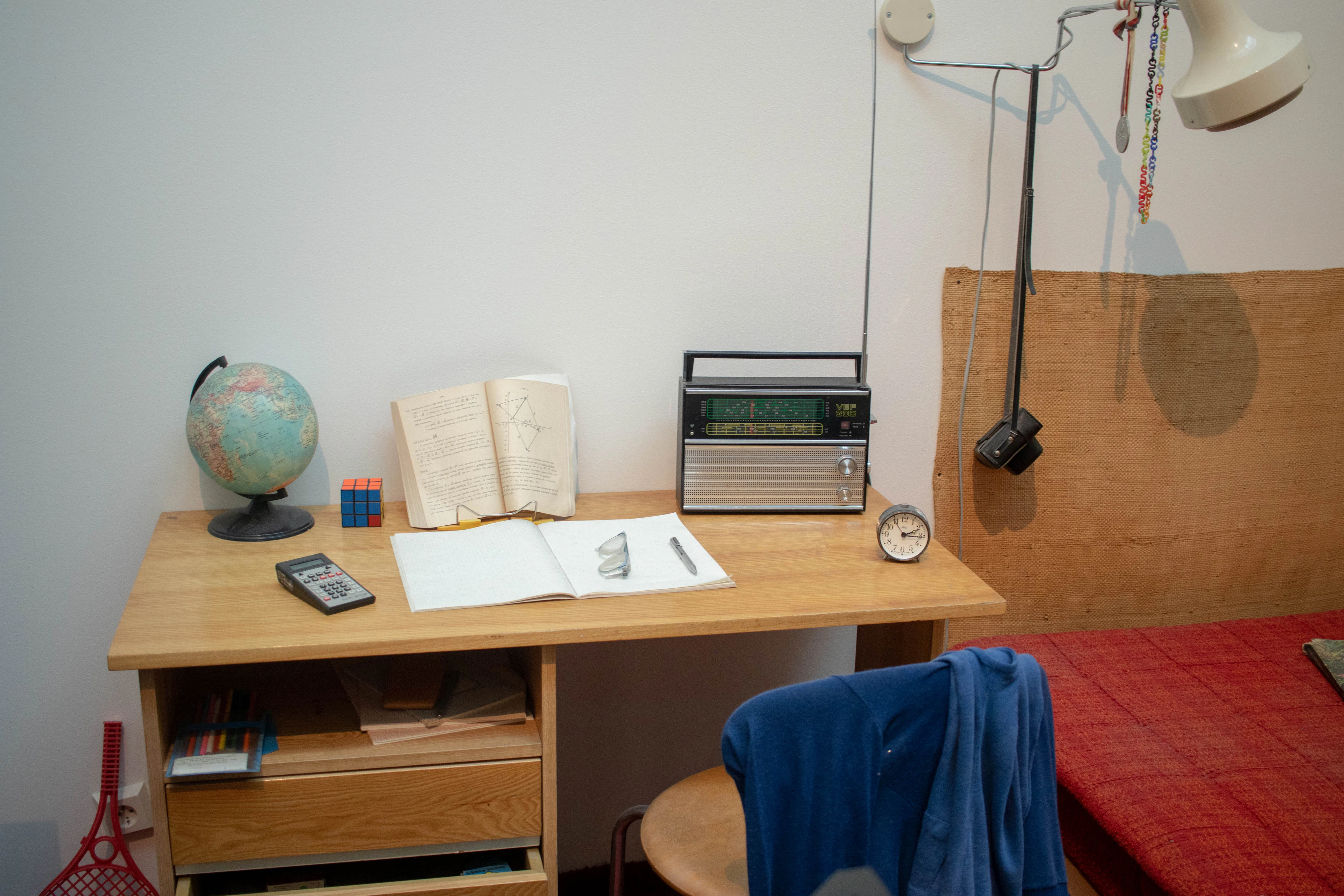 Student's room with a study desk, books and a globe