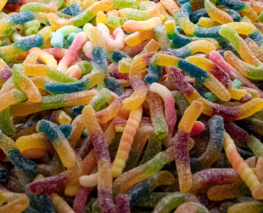 a close up of a pile of candy worms