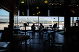 A sketch capturing the fleeting moments of waiting in an airport café.
