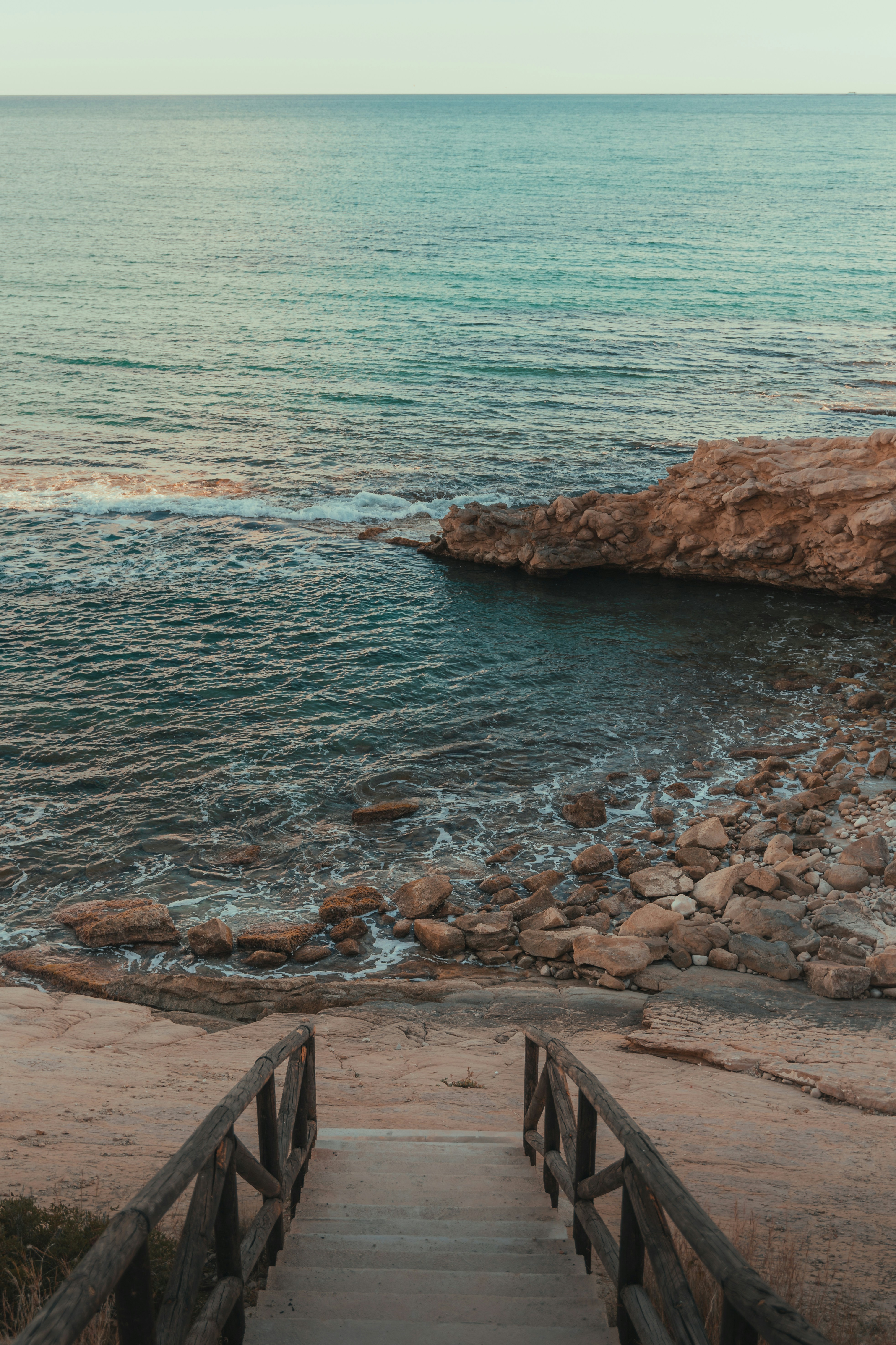 a set of stairs leading down to the ocean