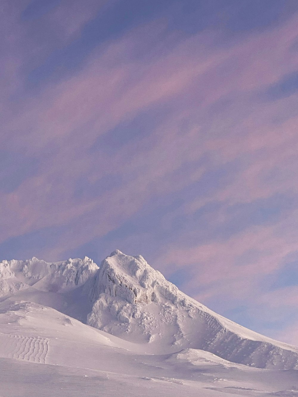 a man riding skis on top of a snow covered slope