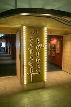 A lively cabaret scene with dancers enjoying French chansons under warm lighting.