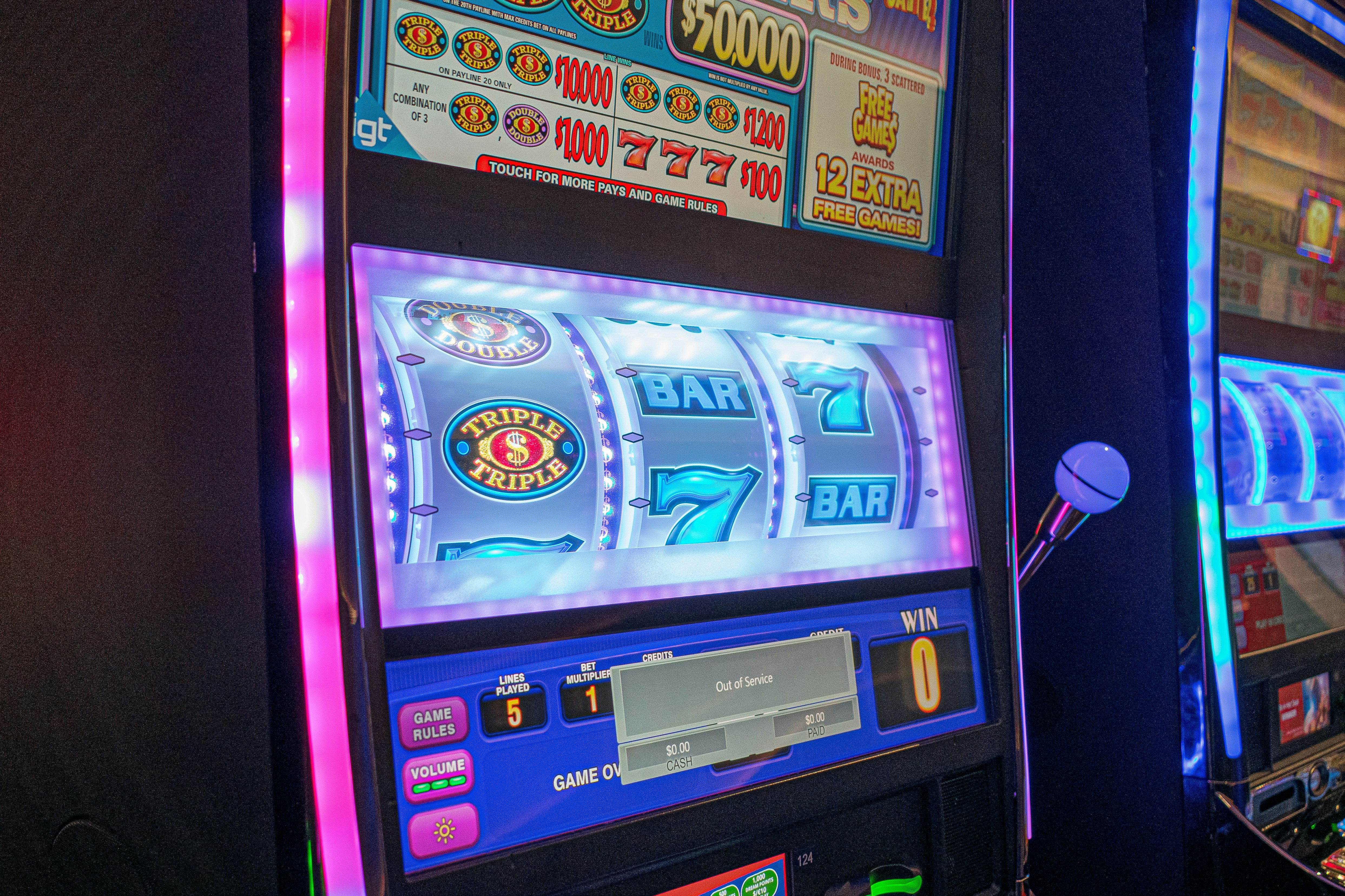 two slot machines with neon lights in a casino