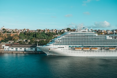 Costa Cruises ship docked at a vibrant port with colorful buildings.