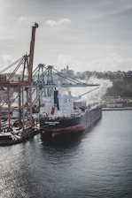 A cargo ship docked at a busy port.