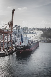 A cargo ship docked at a busy port.