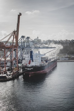 A cargo ship docked at a busy port.