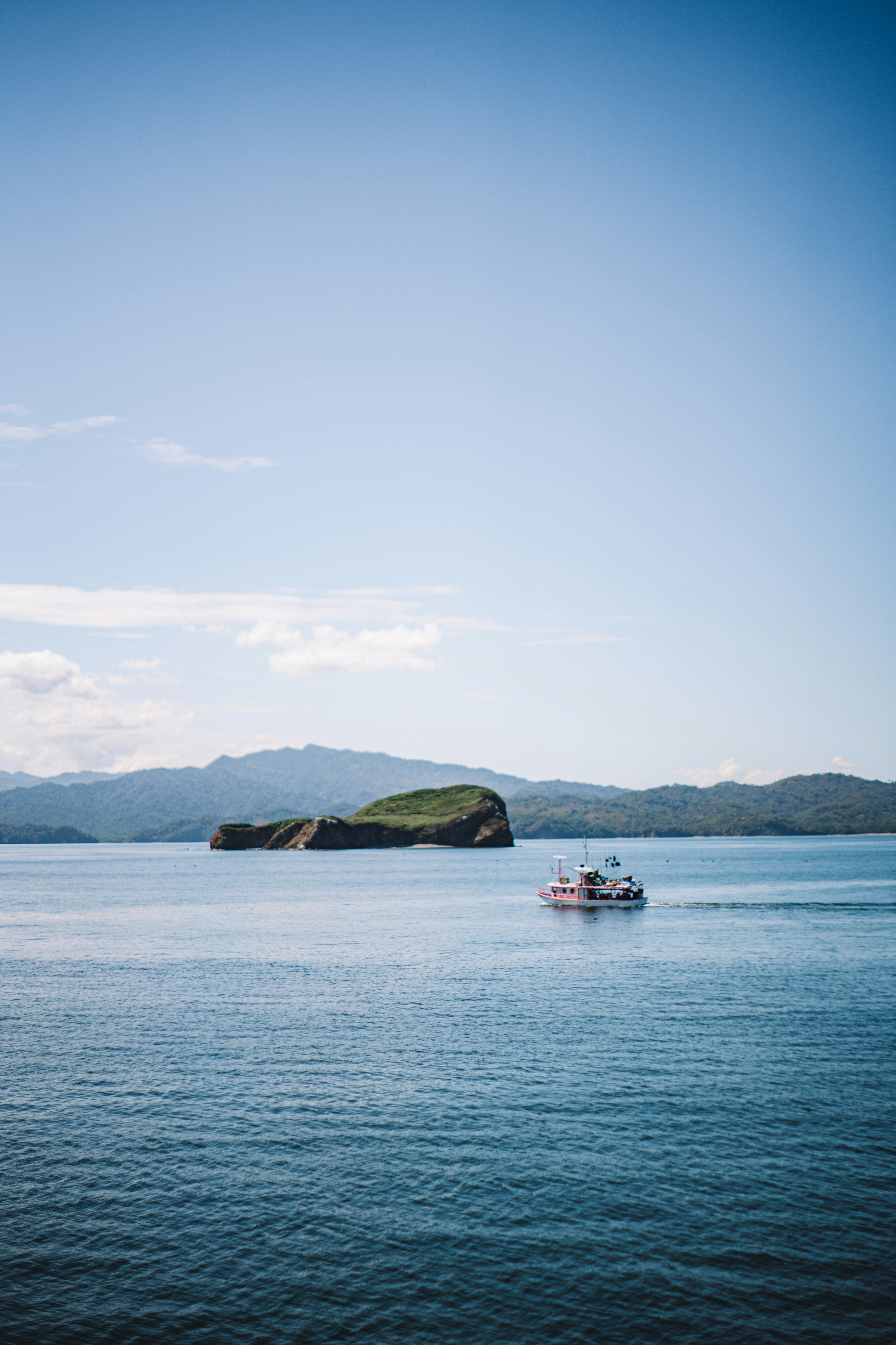 a small boat in the middle of a large body of water