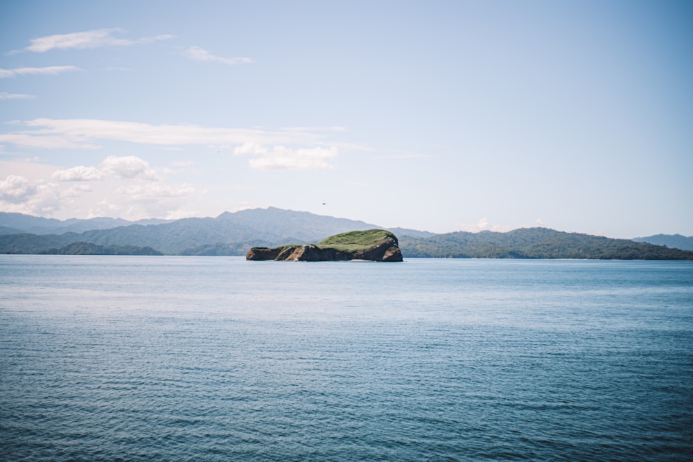 a large body of water with mountains in the background